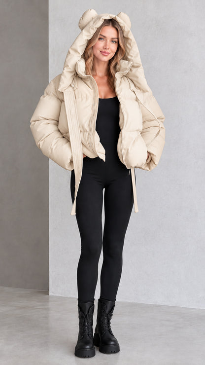 Model wearing beige cream bear ear hooded cropped puffer jacket
