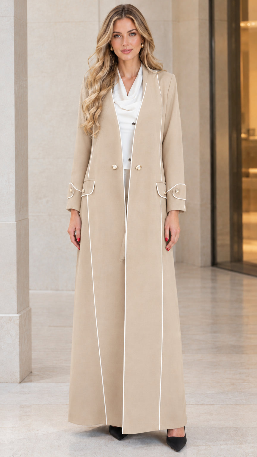 Front view of woman wearing beige neutral longline duster coat with contrast piping